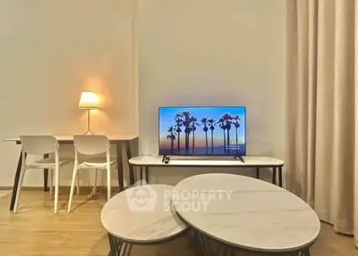 Modern living room with stylish furniture and TV, perfect for relaxation.