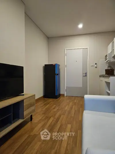 Modern apartment interior with sleek kitchen and cozy living area.