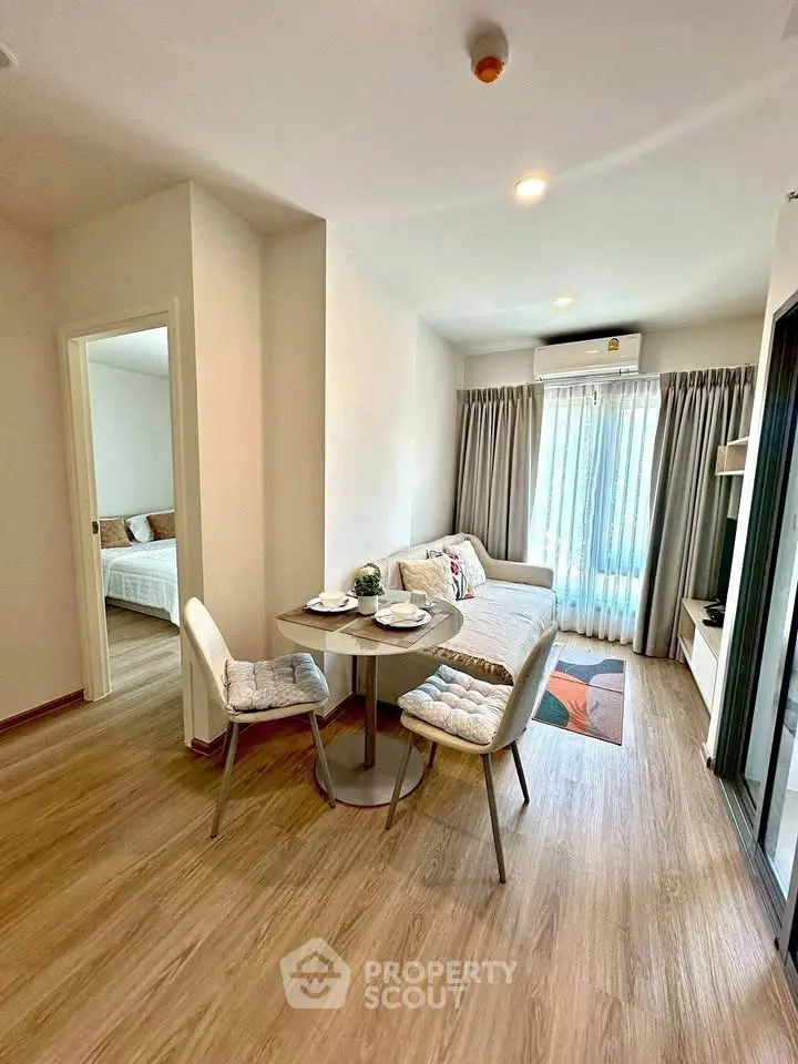 Modern living room with cozy dining area and natural light in stylish apartment.