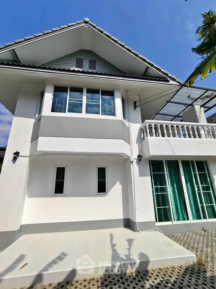 Charming two-story house with modern exterior and balcony, perfect for family living.