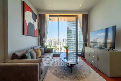 Modern living room with city view, stylish decor, and large windows for natural light.