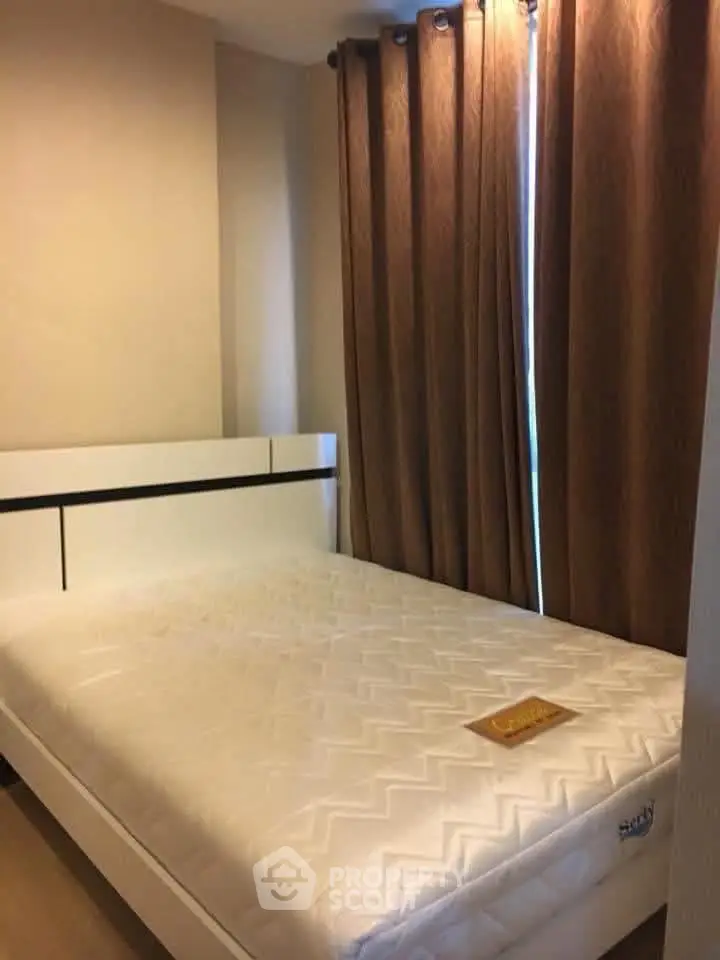 Cozy bedroom with a comfortable mattress and elegant curtains, perfect for restful nights.