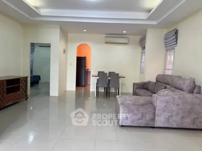 Spacious living room with modern furniture and dining area in open layout.