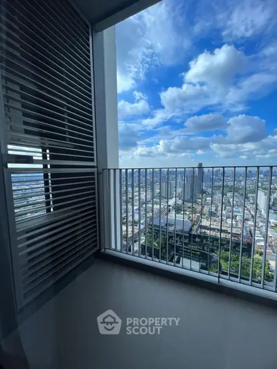 Stunning high-rise balcony with panoramic city views and blue sky.