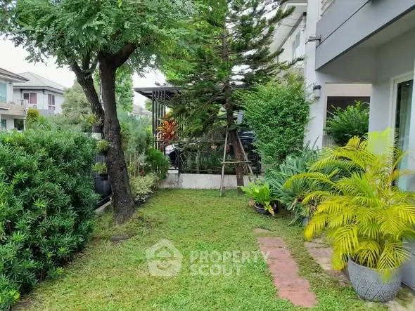 Charming garden view with lush greenery and modern house exterior