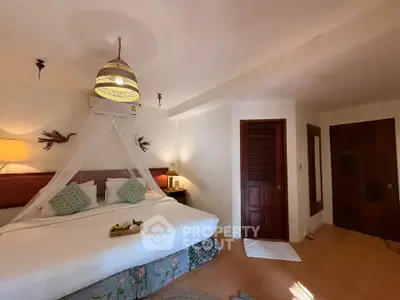 Cozy bedroom with elegant decor and ambient lighting, perfect for relaxation and comfort.