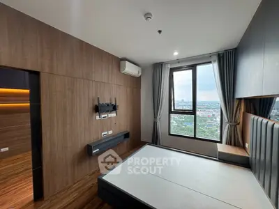 Modern bedroom with large window offering stunning city view, featuring sleek wood paneling and built-in air conditioning.