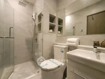 Modern bathroom with sleek shower and elegant fixtures in a contemporary home.
