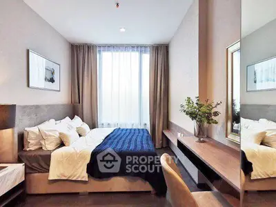 Modern bedroom with stylish decor and large window for natural light.