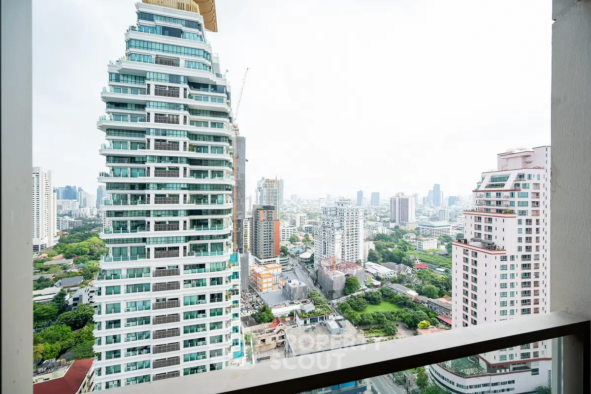 Stunning cityscape view from a high-rise balcony in a modern urban setting.
