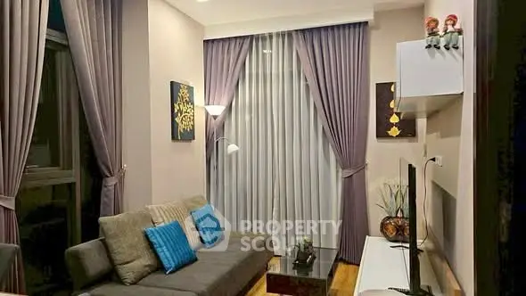 Elegant living room with modern decor and floor-to-ceiling curtains