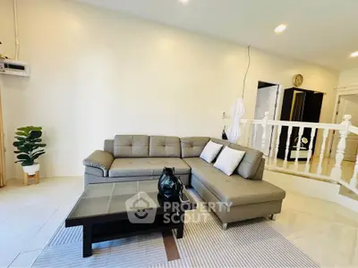 Spacious living room with modern gray sectional sofa and stylish decor