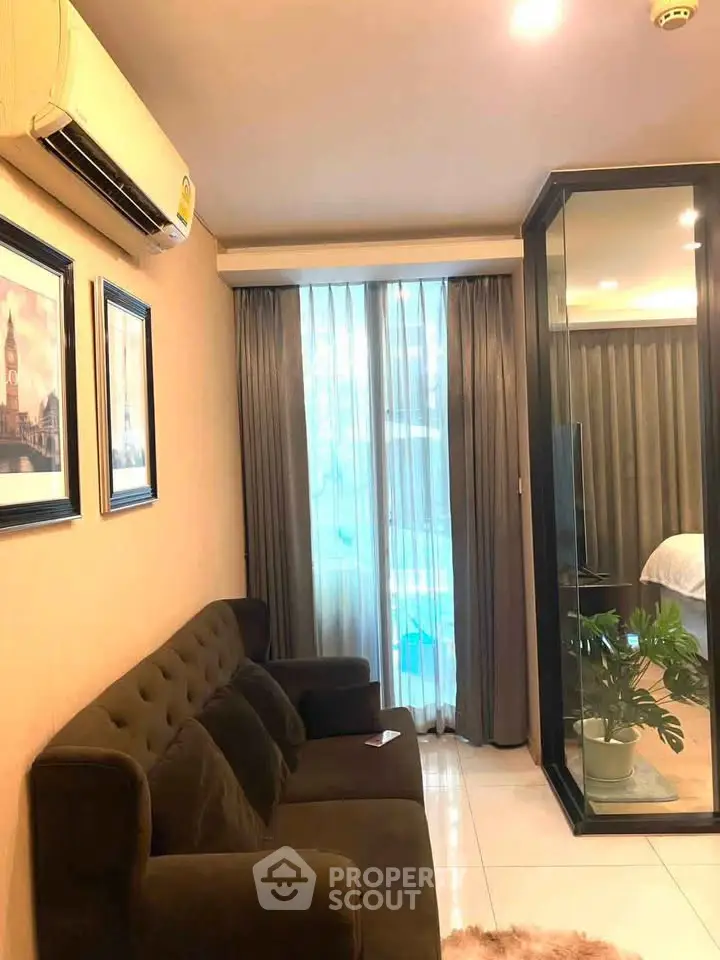 Cozy living room with modern decor and glass partition in stylish apartment