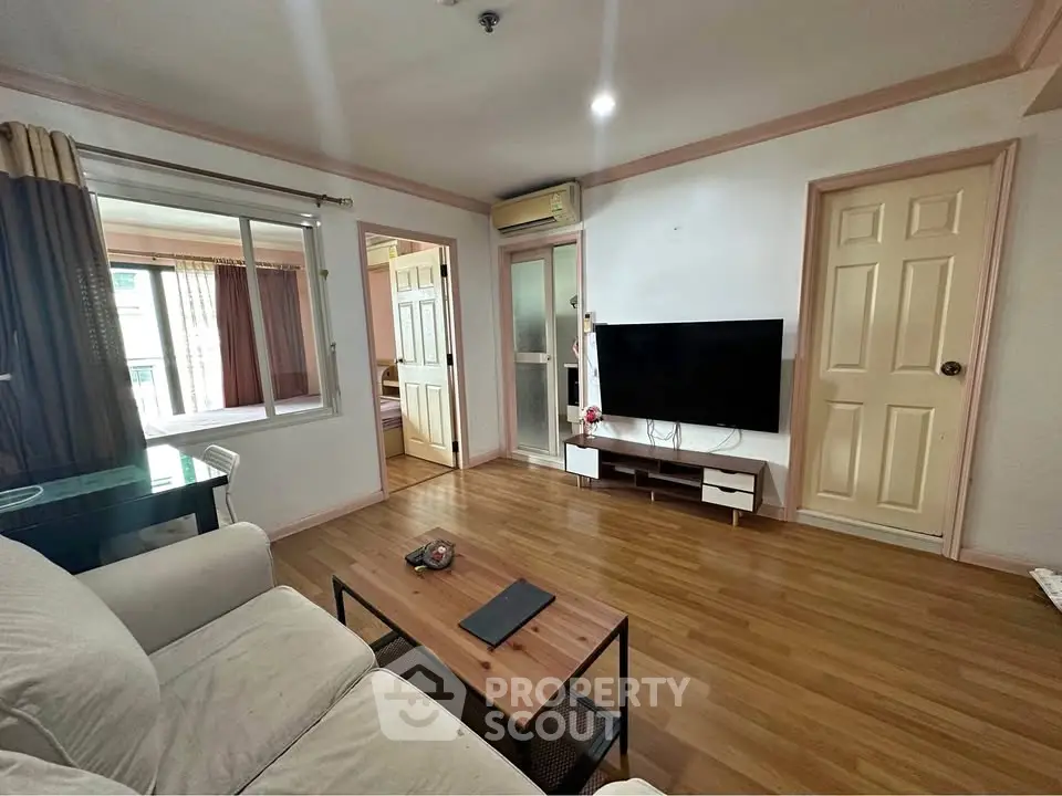 Spacious living room with modern decor and wall-mounted TV