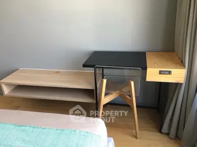 Modern minimalist bedroom with stylish wooden furniture and natural light.