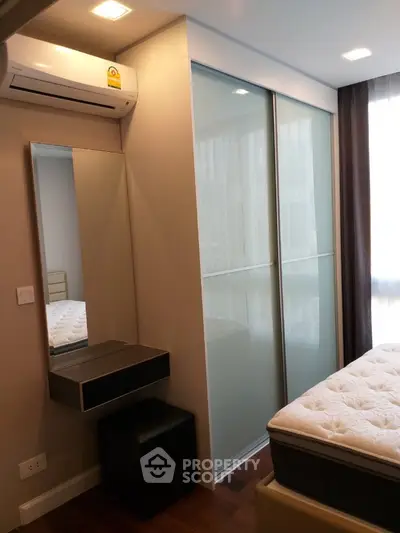 Modern bedroom with sliding closet doors and air conditioning