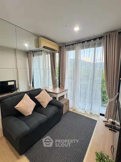 Chic living room with modern decor and balcony view, perfect for urban living.