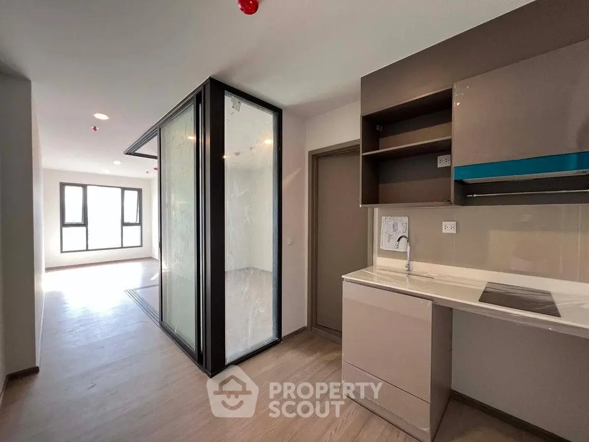 Modern apartment interior with sleek kitchen and bright living area