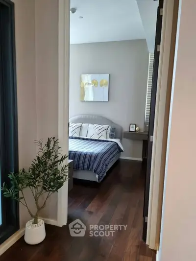 Cozy bedroom with modern decor and wooden flooring, perfect for relaxation.