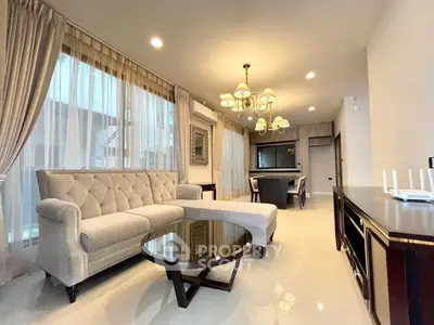 Luxurious living room with elegant chandelier and plush sofa in modern home