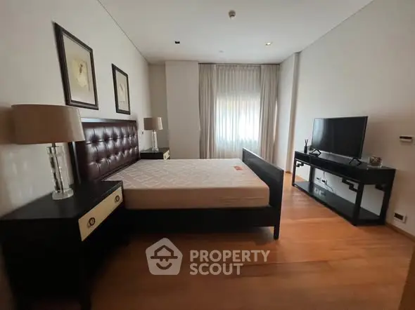 Spacious bedroom with modern furniture and natural light