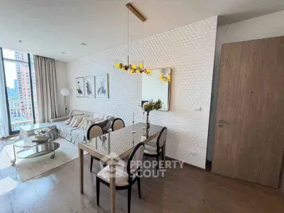Modern living room with elegant dining area and stylish decor in a high-rise apartment.