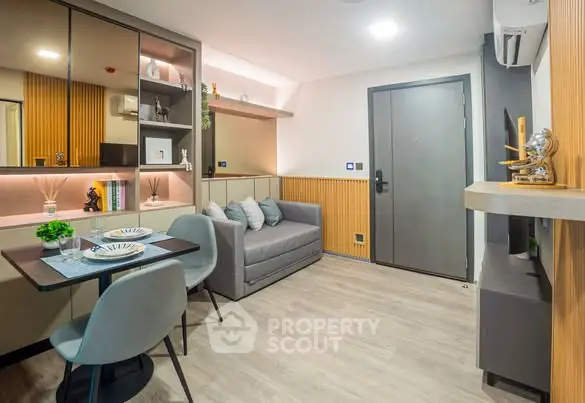 Modern living room with stylish decor and dining area in a cozy apartment.