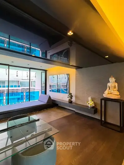 Modern living room with glass table, large windows, and serene decor overlooking urban view.