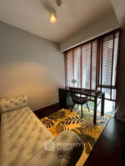 Cozy study room with elegant chaise lounge and stylish desk by large window