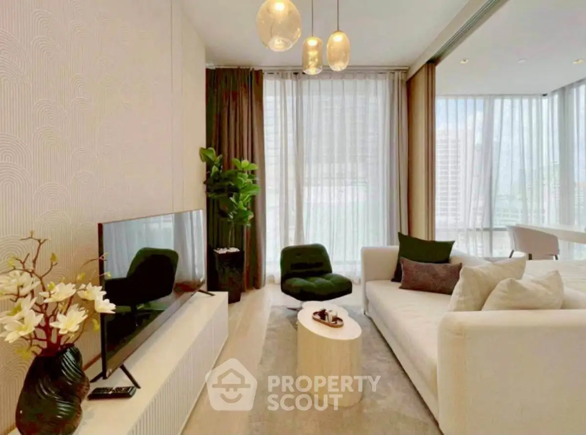 Modern living room with elegant decor, large windows, and stylish furniture in a luxury apartment.