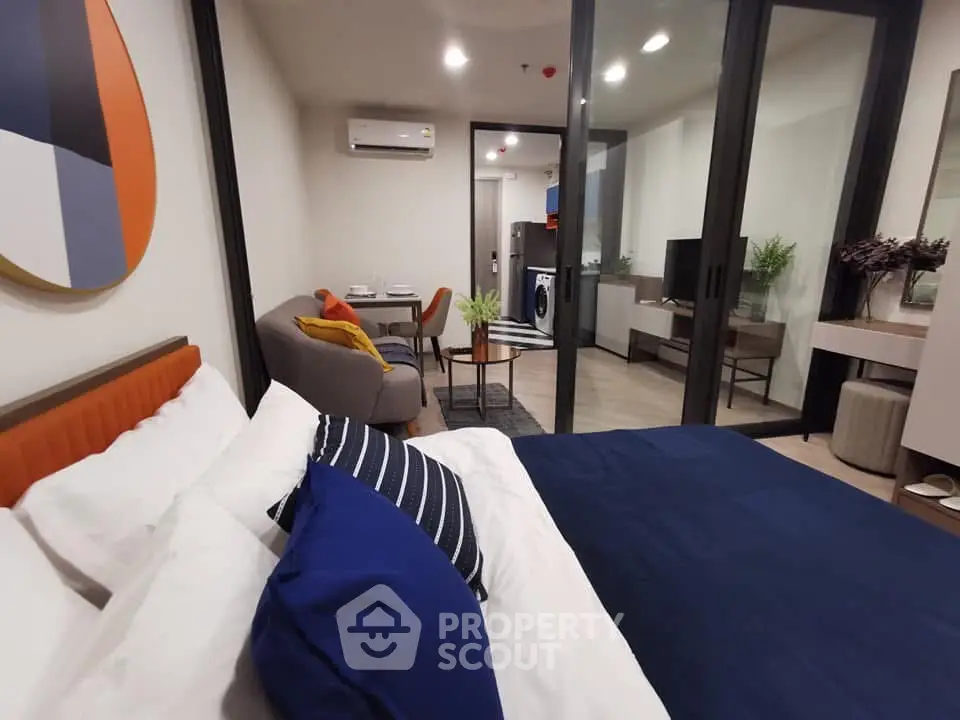 Modern studio apartment with stylish decor and open layout, featuring a cozy living area and bedroom.