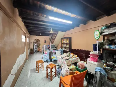 Spacious living area with rustic wooden ceiling and eclectic decor
