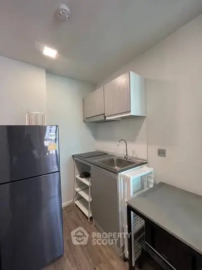 Modern compact kitchen with sleek cabinets and stainless steel sink