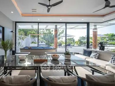 Luxurious open-plan living room with pool view and modern decor