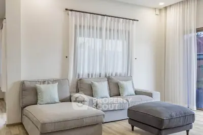 Elegant living room with cozy gray sofas and natural light