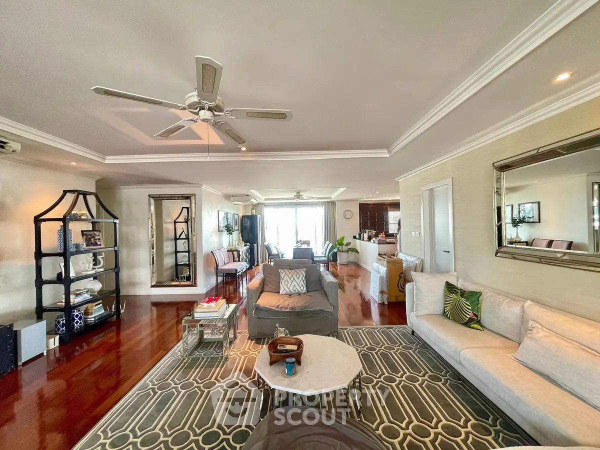 Spacious and elegant living room with modern decor and hardwood floors, perfect for entertaining.