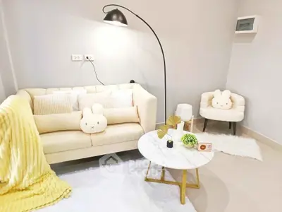 Charming living room with cozy seating and stylish decor, perfect for relaxation and entertaining.