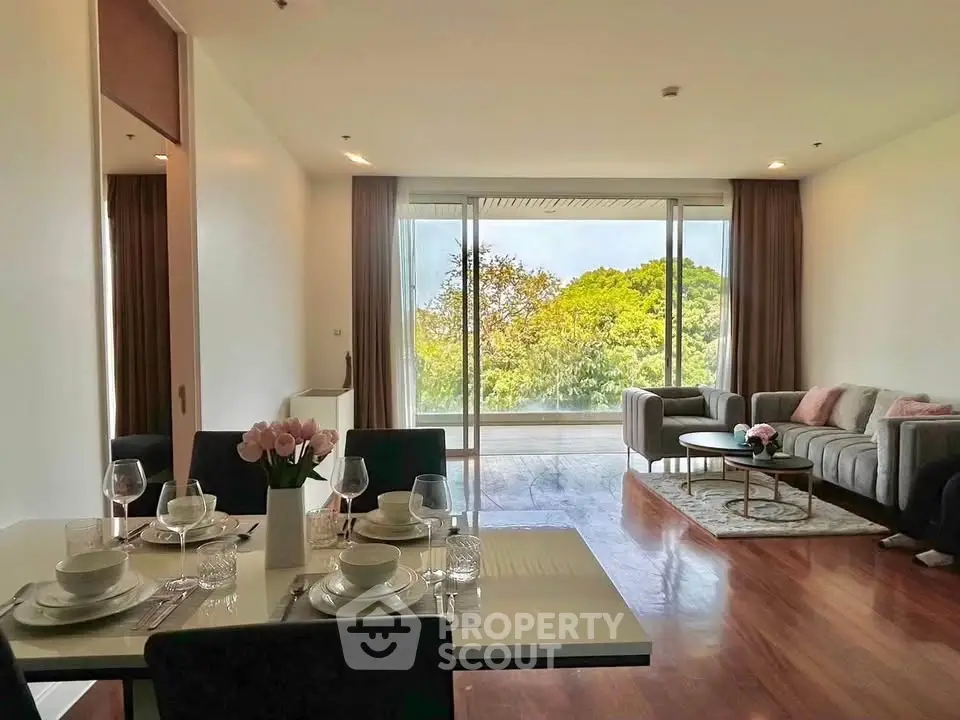 Spacious living and dining area with large windows and scenic view, perfect for modern living.