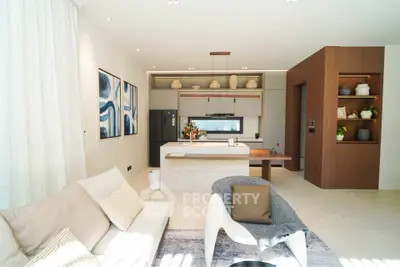 Modern open-layout kitchen and living room with stylish decor and natural light.