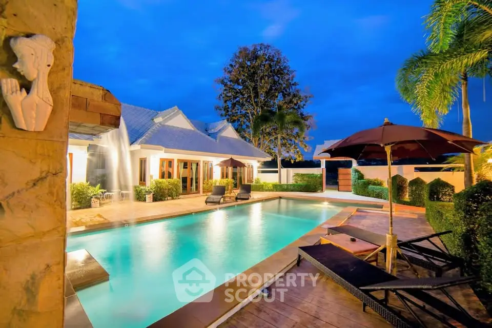 Luxurious villa with stunning pool and lush garden at sunset, perfect for relaxation and entertainment.