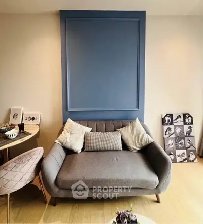 Stylish living room with modern sofa and elegant decor in a cozy apartment setting.