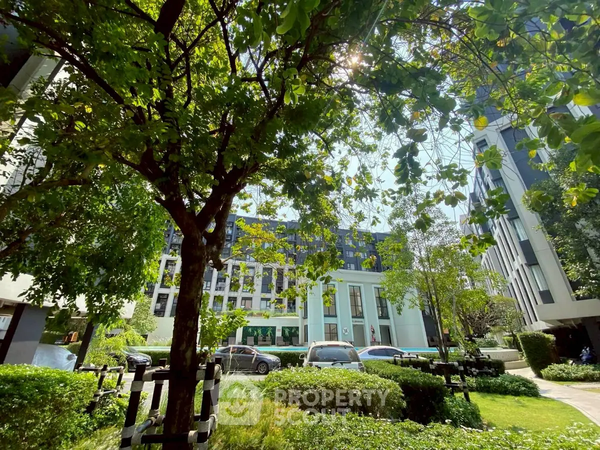 Lush garden view with modern building backdrop, perfect for urban nature lovers.