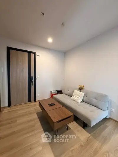 Cozy living room with modern sofa and wooden coffee table in a stylish apartment.