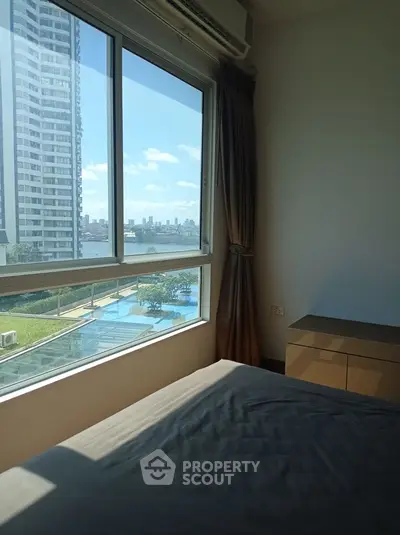 Stunning bedroom with river view in modern high-rise apartment