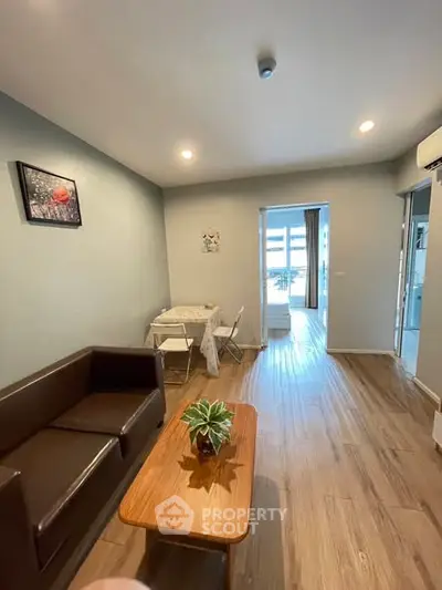 Modern living room with wooden flooring and stylish furniture in a cozy apartment.