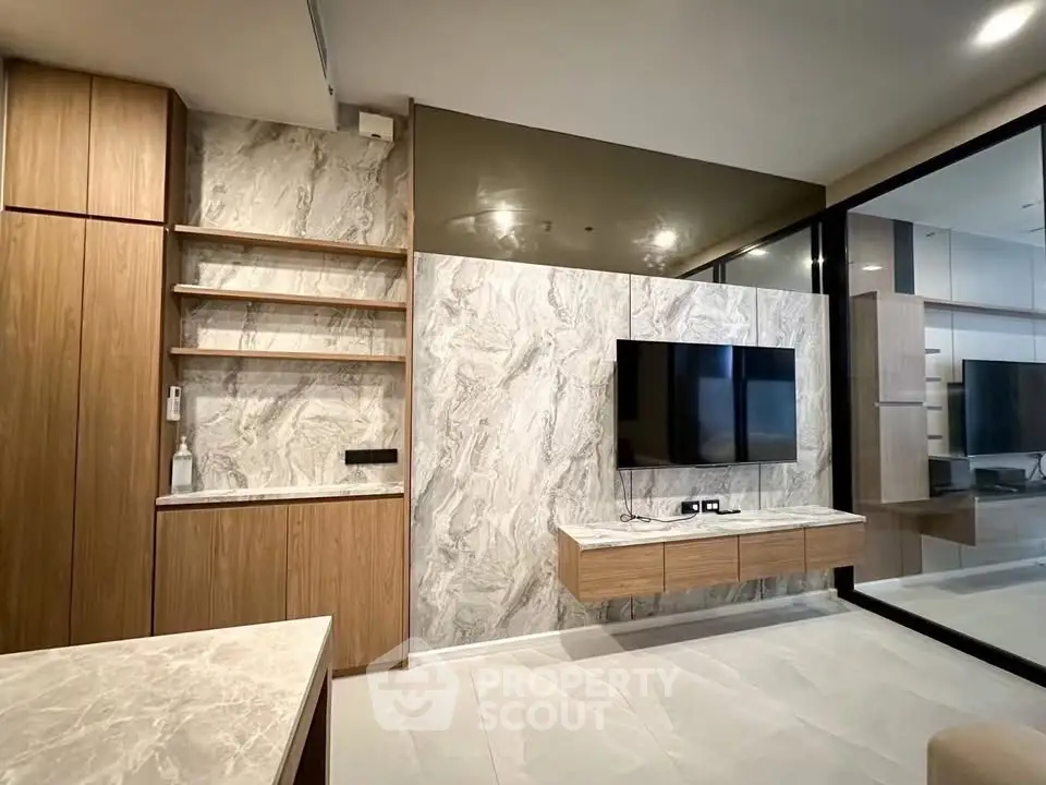 Modern living room with marble accents and wall-mounted TV