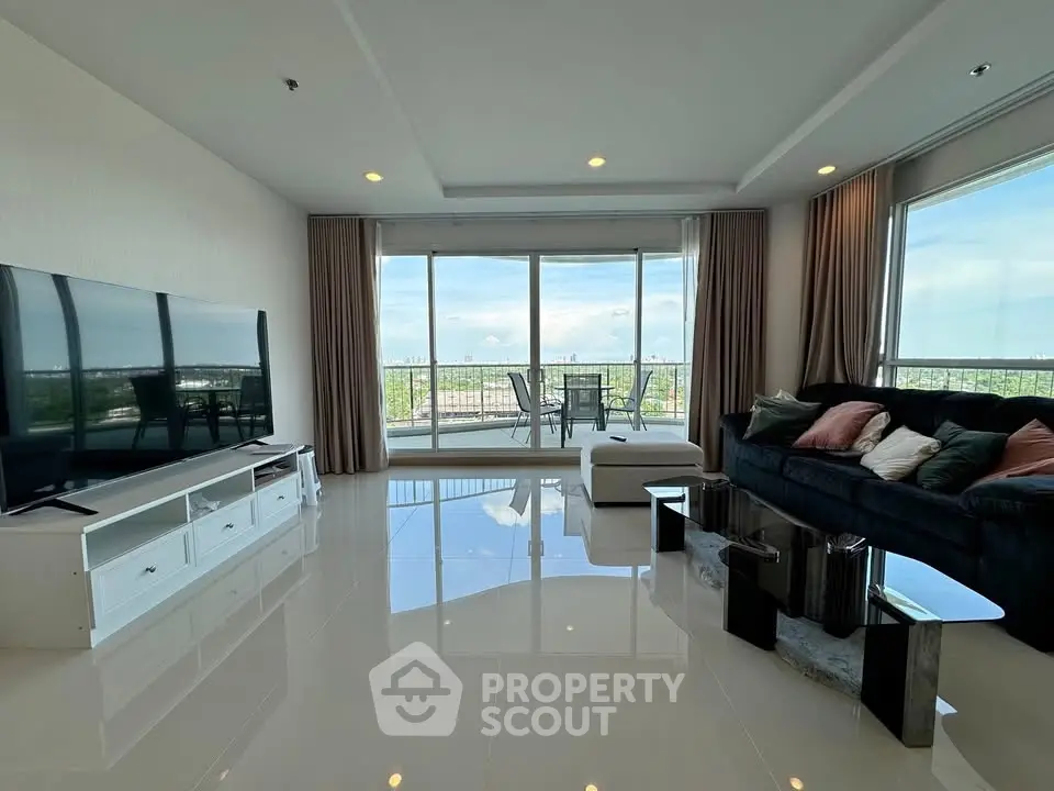 Spacious living room with modern decor and stunning balcony view