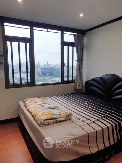 Cozy bedroom with city view and large windows
