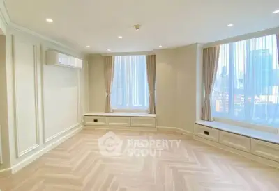 Spacious and elegant living room with large windows and city view