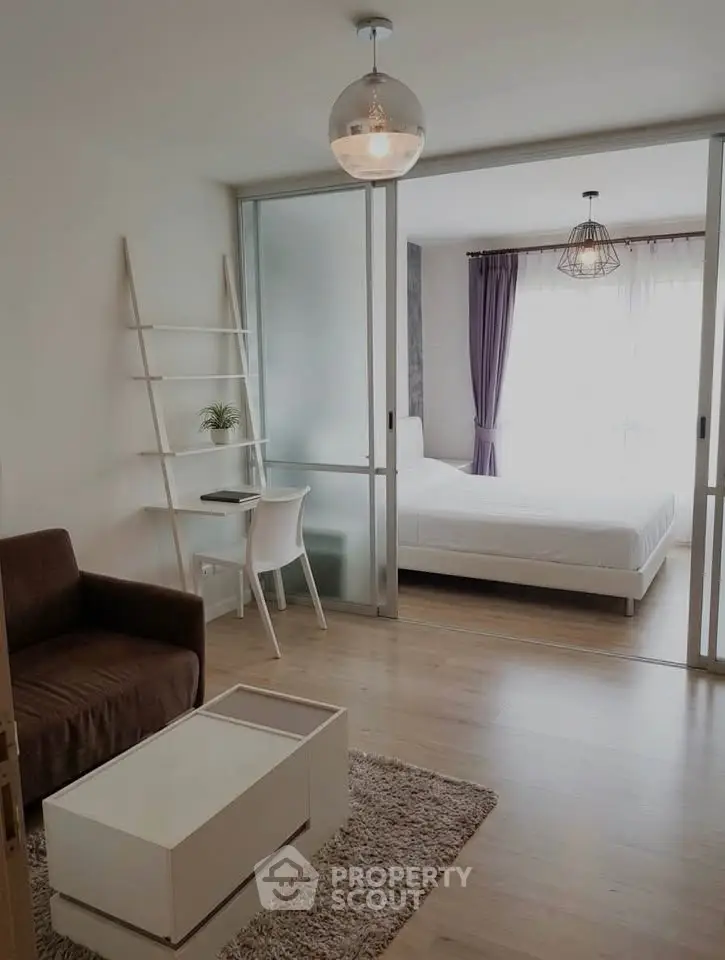 Modern studio apartment with sliding glass doors, cozy living area, and stylish bedroom.